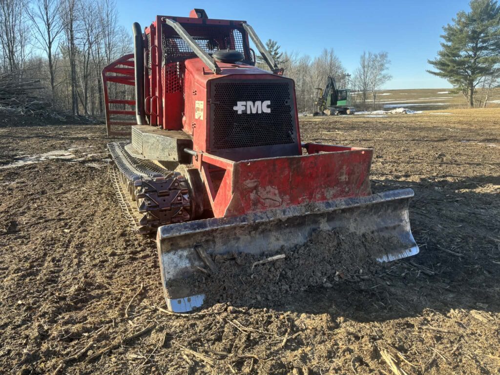 Red FMC Track Skidder for sale - Used FMC 2400 forestry equipment with front blade in the USA.