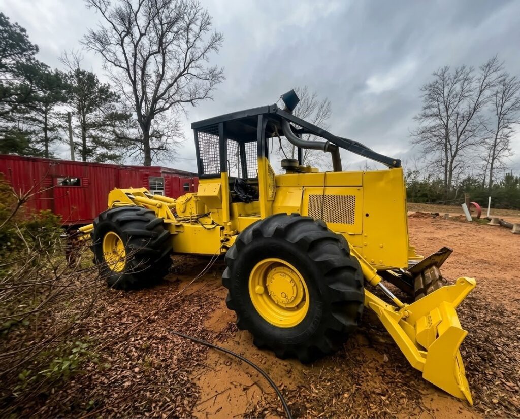 1995 cat 518 Grapple skidders stand on a field